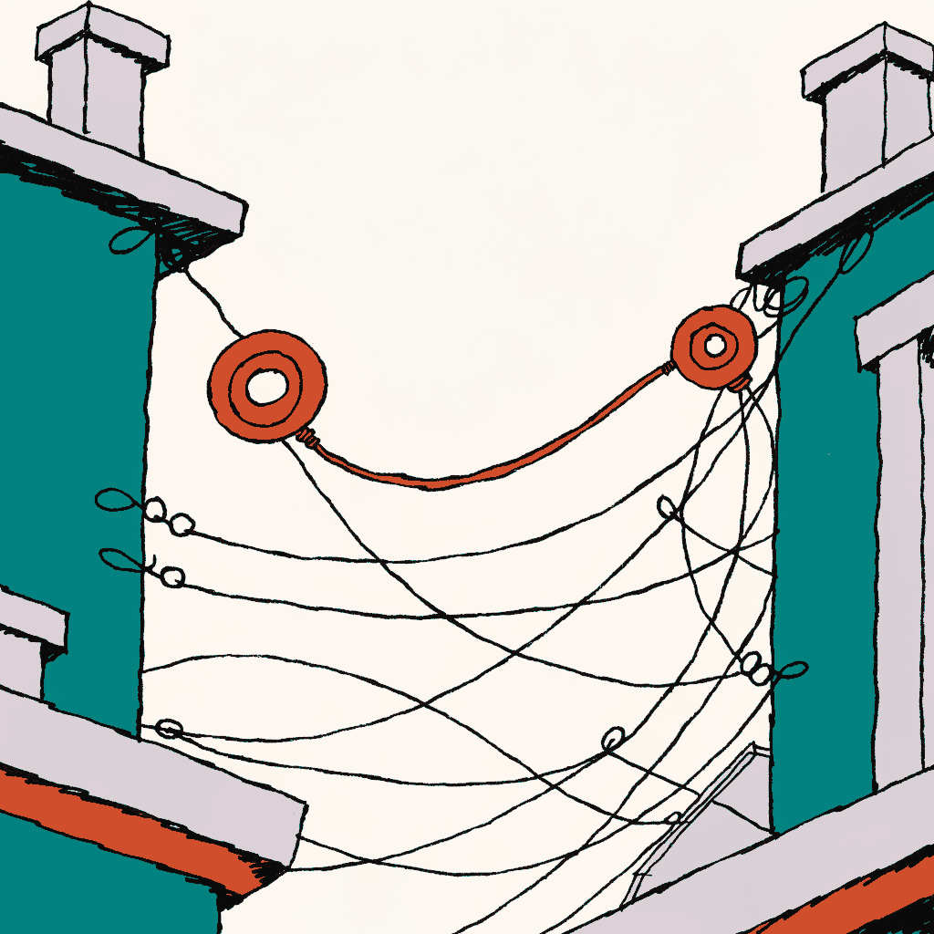 A dense tangle of telephone wires strung between two rooftops