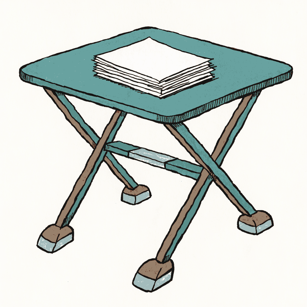 A folding information table with leaflets stacked on it