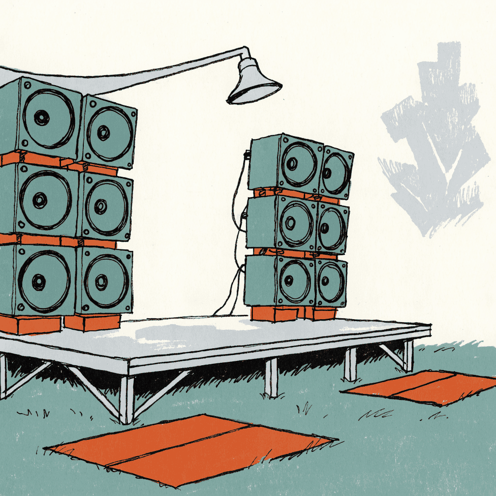 An empty outdoor stage with a bank of loudspeakers