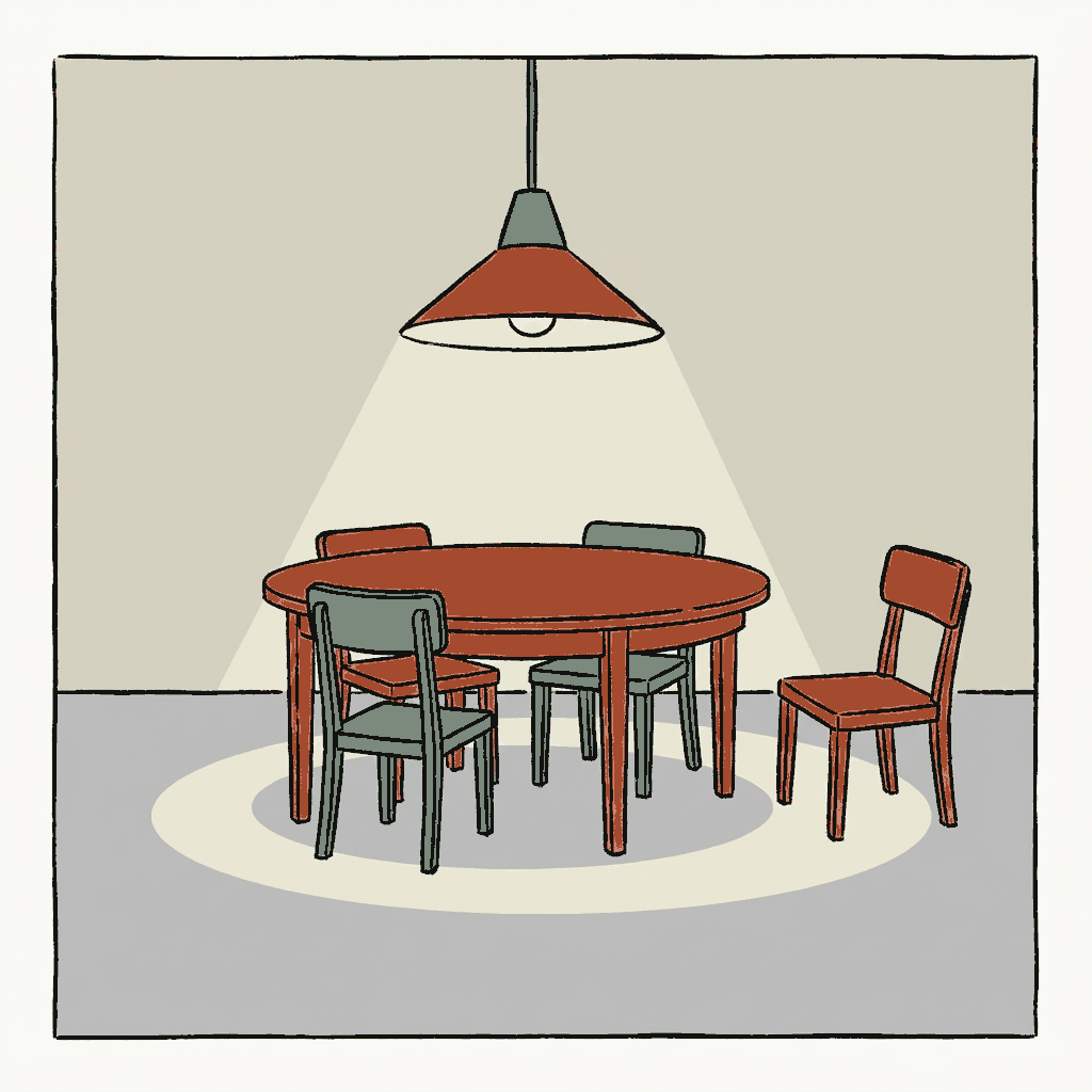 A round table in a dim room lit by one hanging lamp, every chair pushed in but one