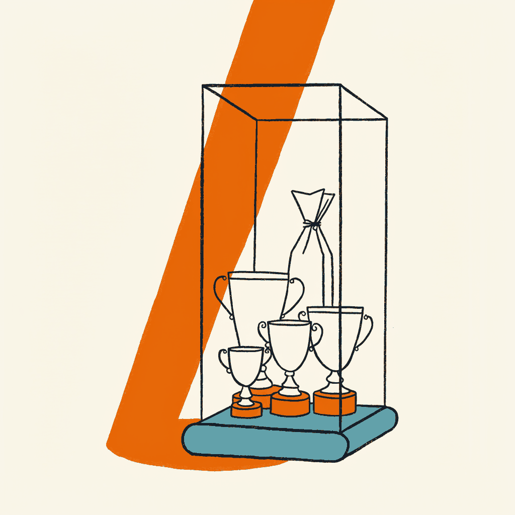A spotlit glass trophy cabinet with a sealed clear document pouch standing among the silver cups